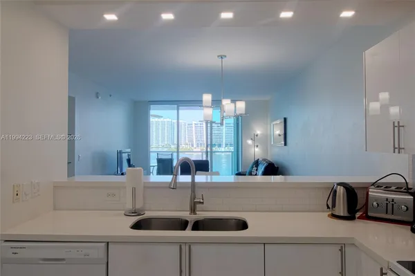 a kitchen with a sink and a refrigerator