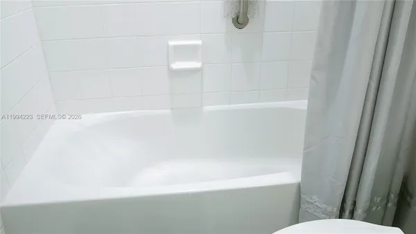 a bathroom with a shower and a toilet