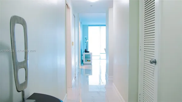 a bathroom with a glass door shower and a sink
