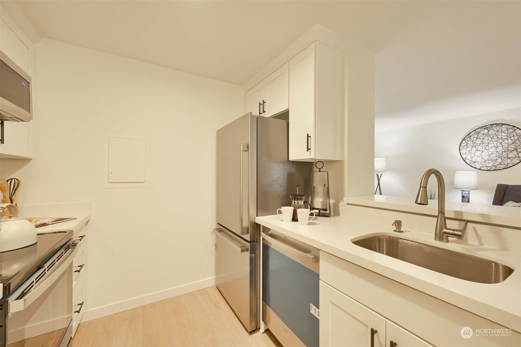 17536 149th Avenue Southeast, Unit O 9 Renton, WA 98058 - Photo 11 of 20 a kitchen with stainless steel appliances granite countertop a sink stove and refrigerator