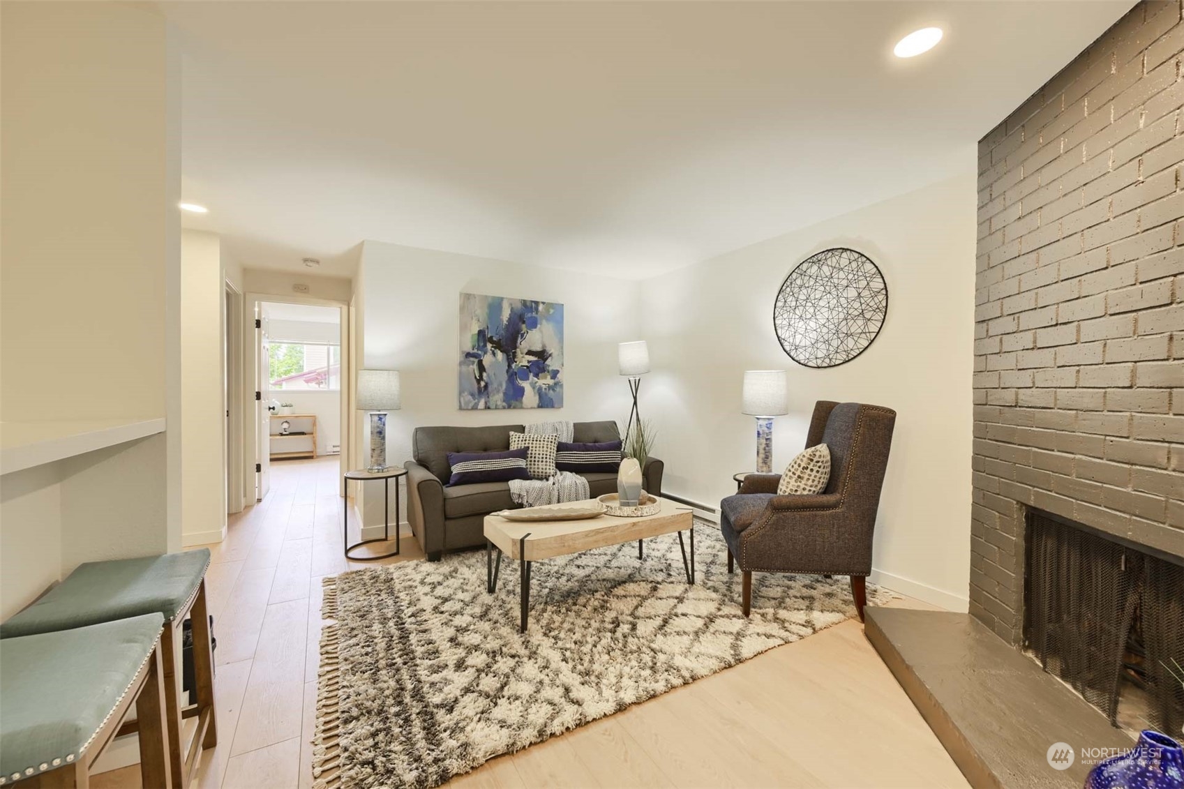 17536 149th Avenue Southeast, Unit O 9 Renton, WA 98058 - Photo 4 of 20 a living room with furniture a clock and wall paintings