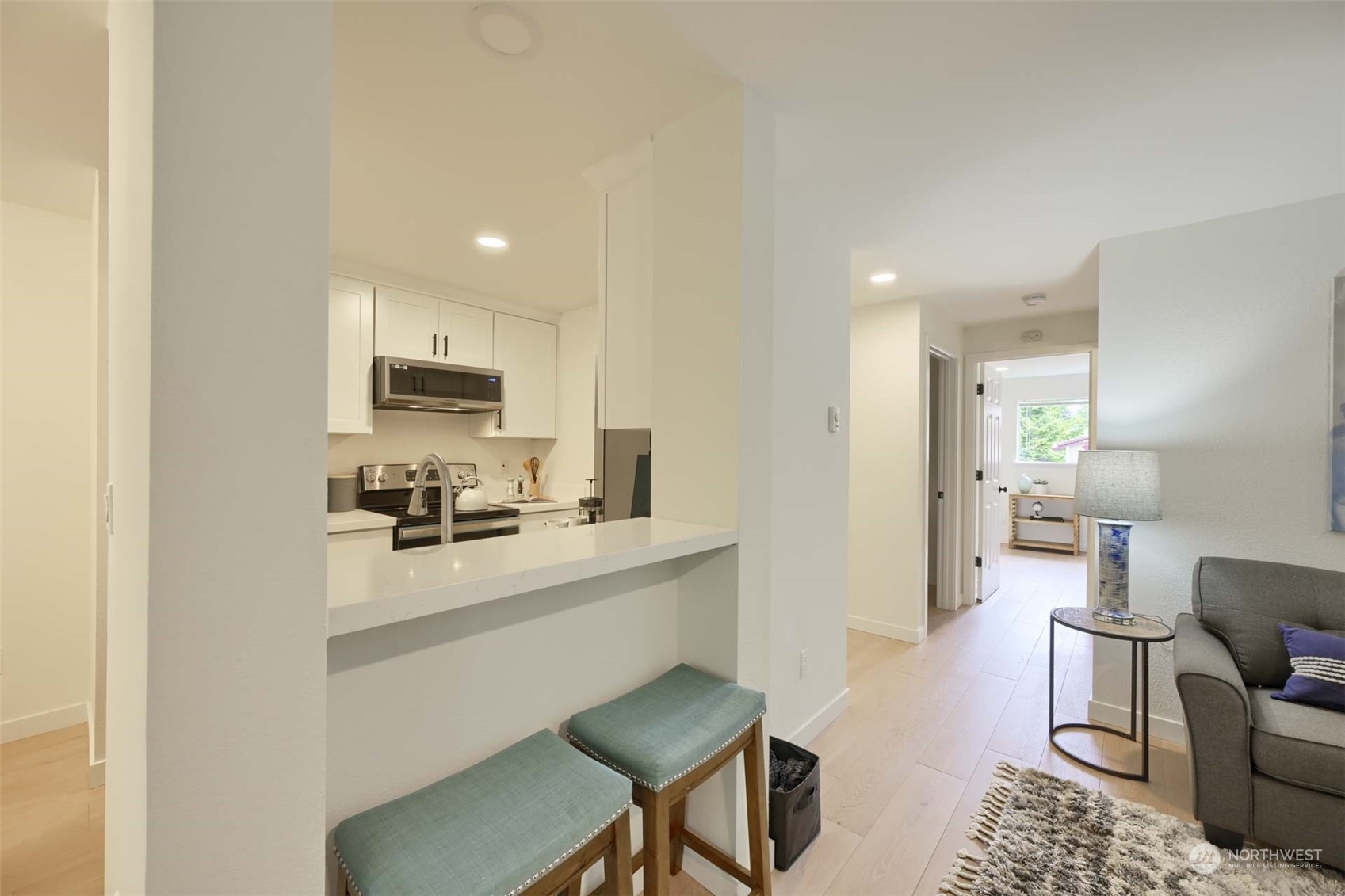17536 149th Avenue Southeast, Unit O 9 Renton, WA 98058 - Photo 5 of 20 a kitchen with a sink a stove a refrigerator cabinets and chairs
