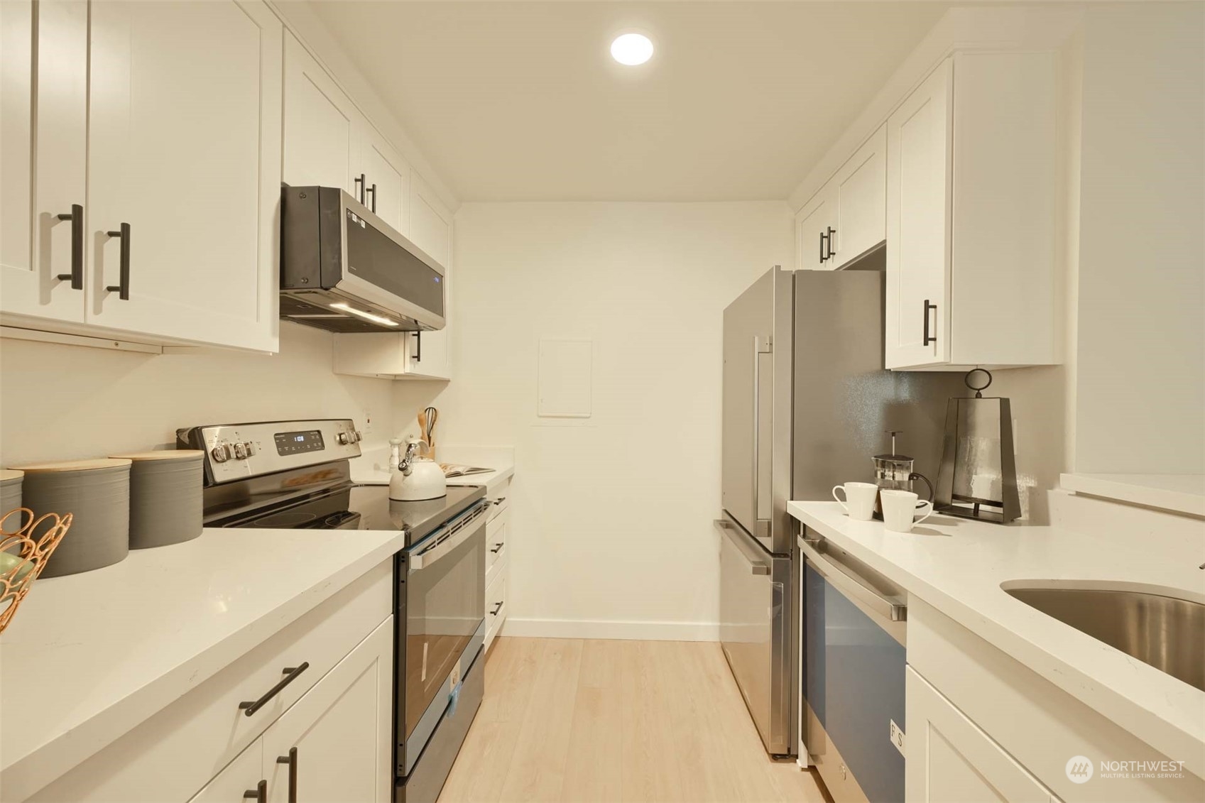 17536 149th Avenue Southeast, Unit O 9 Renton, WA 98058 - Photo 9 of 20 a kitchen with stainless steel appliances granite countertop a sink stove and refrigerator