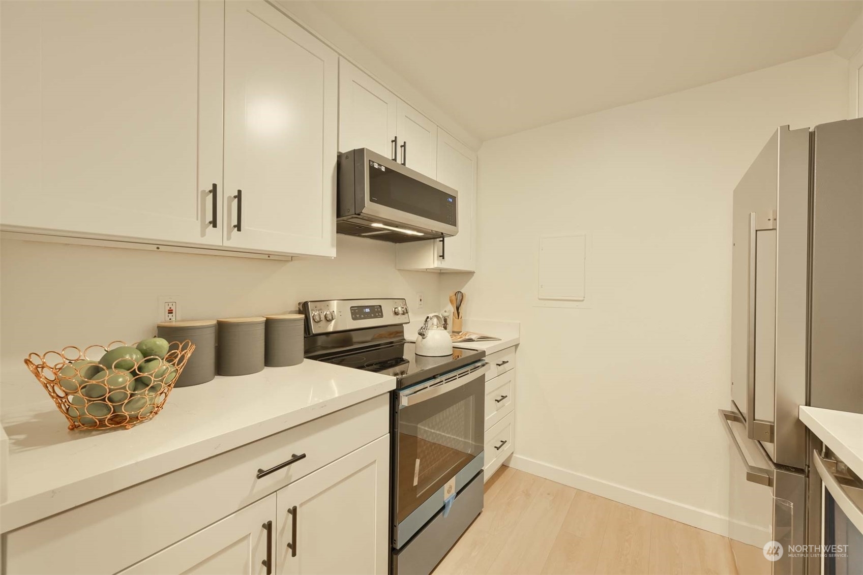17536 149th Avenue Southeast, Unit O 9 Renton, WA 98058 - Photo 10 of 20 a kitchen with stainless steel appliances a stove a microwave and cabinets