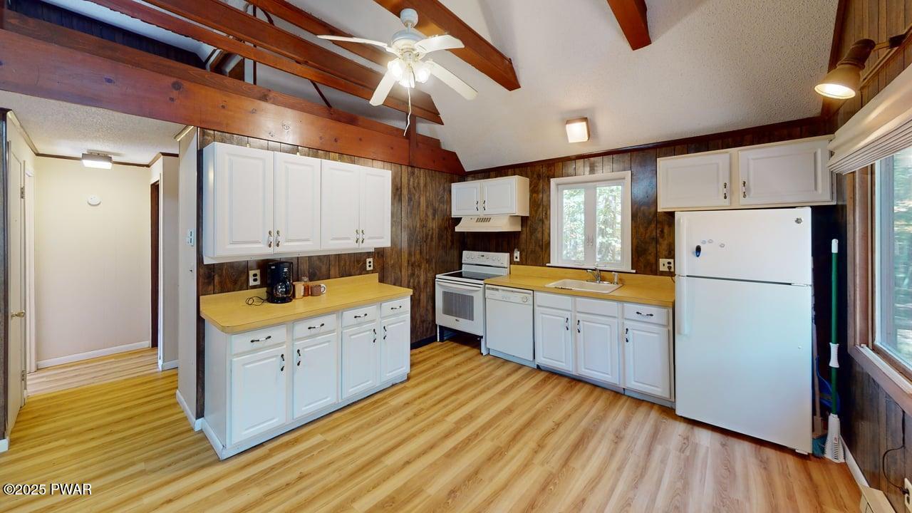 105 Roundhill Road Dingmans Ferry, PA 18328 - Photo 5 of 18 a kitchen with cabinets a sink and wooden floor