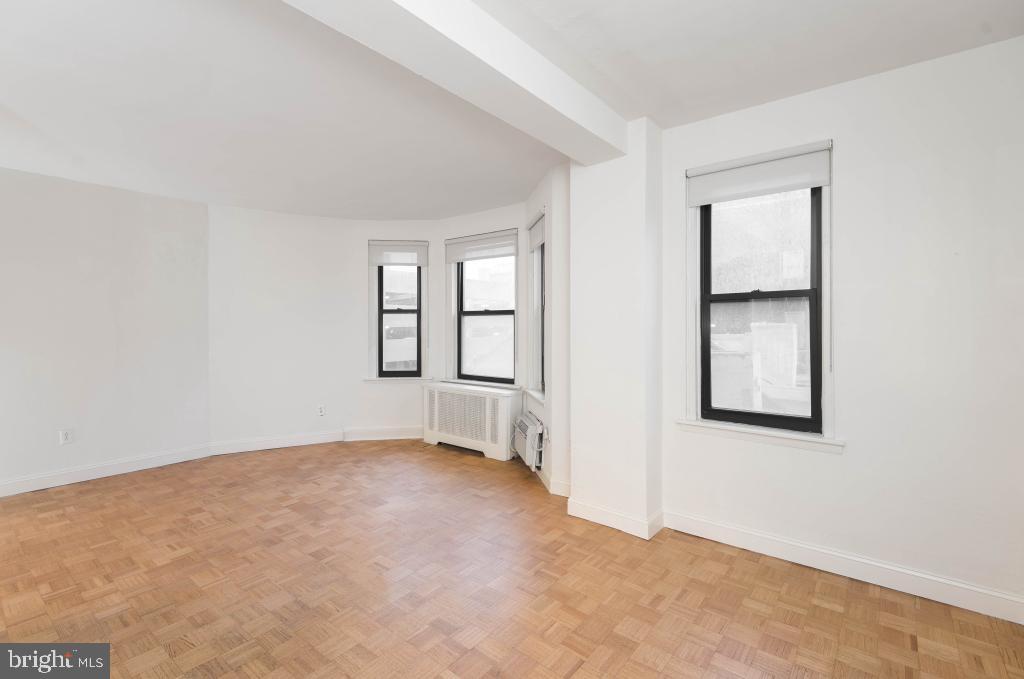 1218 Walnut Street, Unit 205 Philadelphia, PA 19107 - Photo 14 of 17 an empty room with windows and closet
