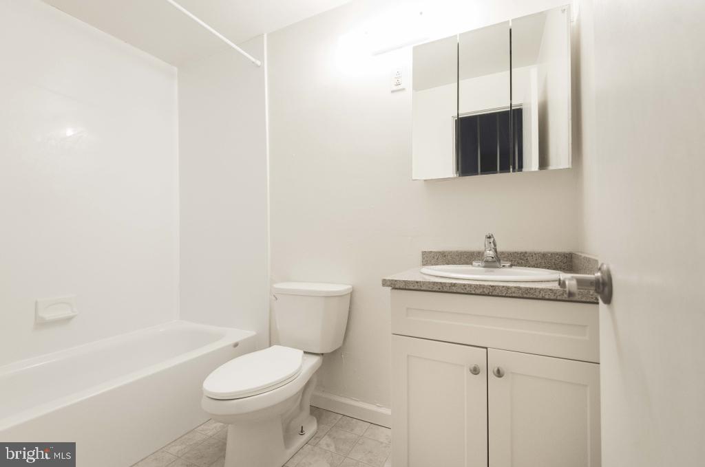 1218 Walnut Street, Unit 205 Philadelphia, PA 19107 - Photo 16 of 17 a bathroom with a toilet sink and mirror