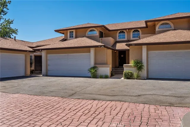 a front view of a house with a yard and a garage