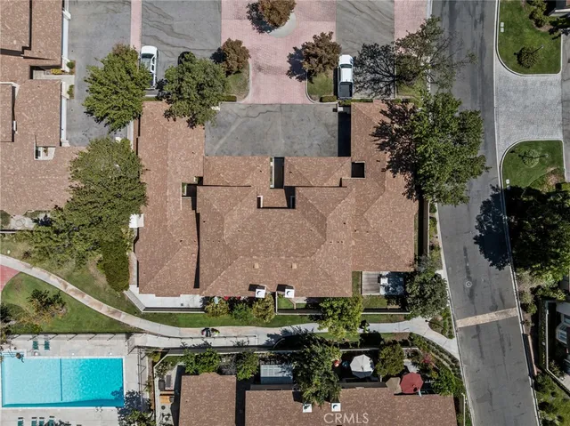 an aerial view of a house with a yard