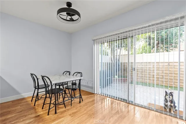 a view of a dining room with furniture wooden floor and windows
