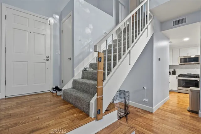 a view of entryway and hall with wooden floor