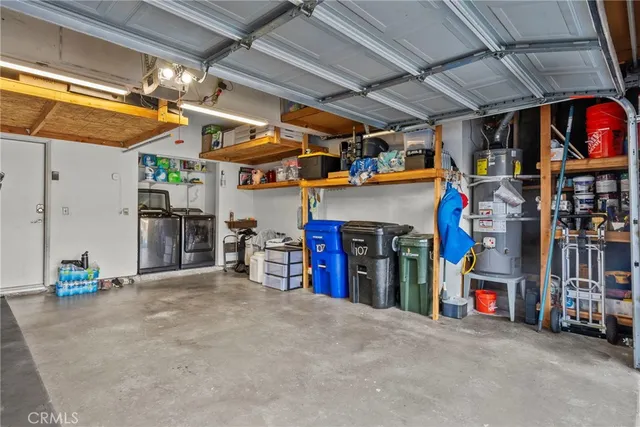 a view of a patio with table and chairs with wooden fence and plants