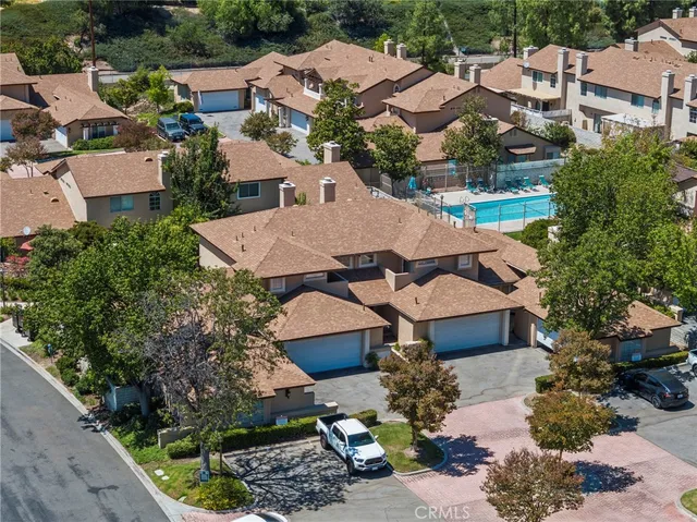 an aerial view of multiple houses with yard