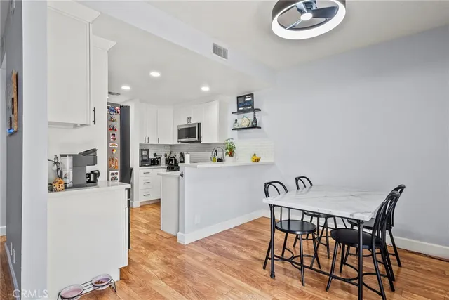 a view of kitchen with cabinets and wooden floor