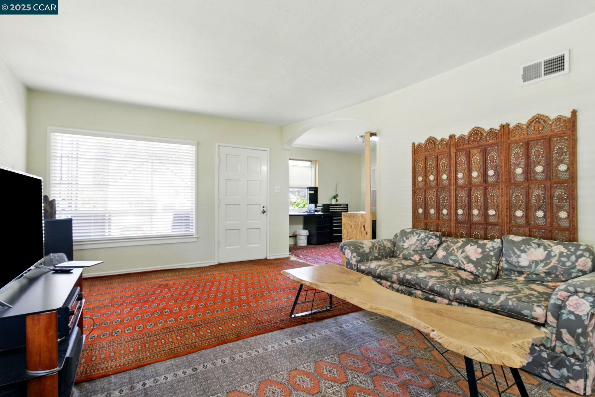500 Wano Street Martinez, CA 94553 - Photo 12 of 30 a living room with furniture a flat screen tv and a window