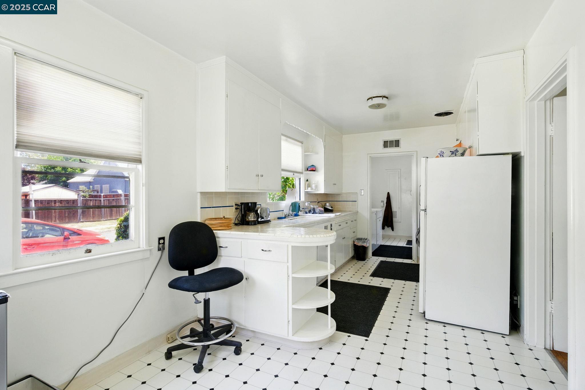 500 Wano Street Martinez, CA 94553 - Photo 13 of 30 a kitchen with a sink a stove a refrigerator and white cabinets