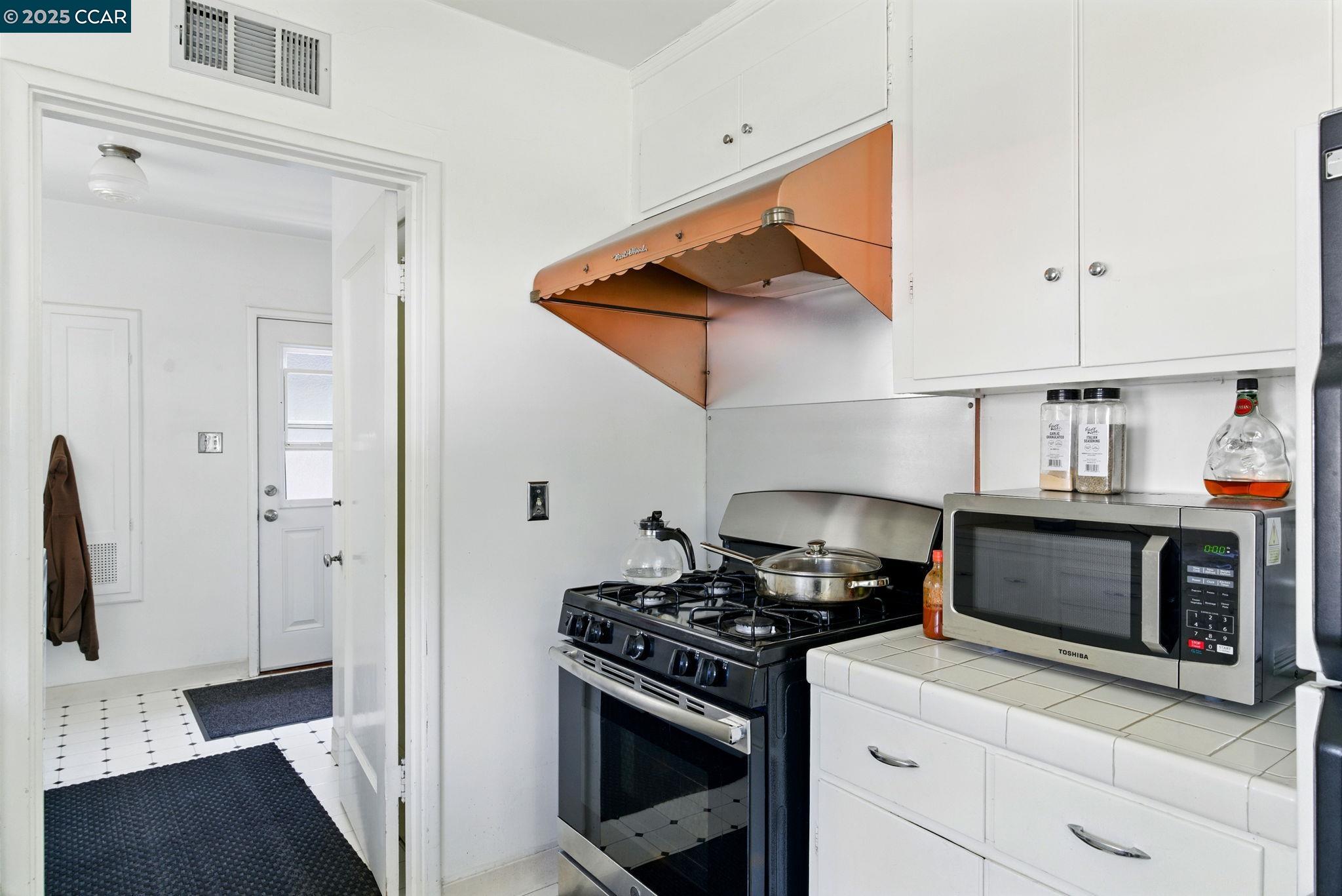 500 Wano Street Martinez, CA 94553 - Photo 16 of 30 a kitchen with stainless steel appliances kitchen island a stove and a refrigerator
