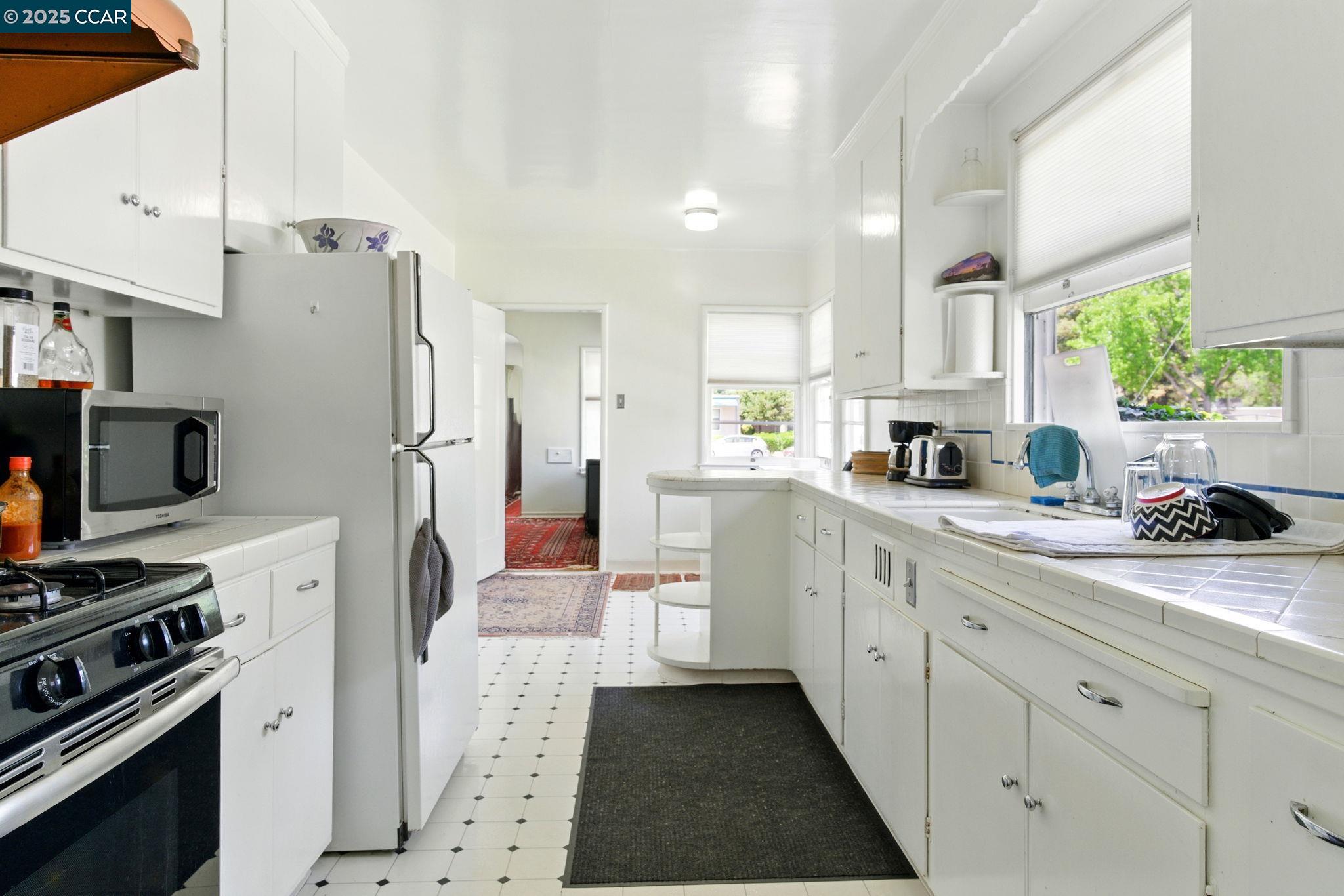 500 Wano Street Martinez, CA 94553 - Photo 18 of 30 a kitchen with white cabinets and appliances
