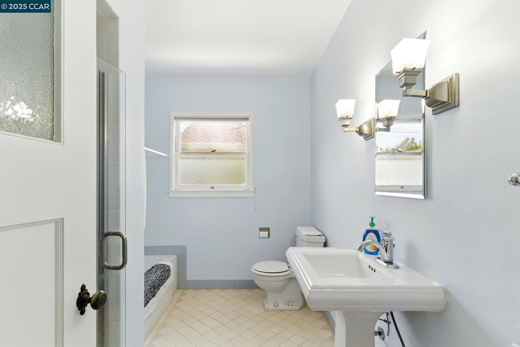 500 Wano Street Martinez, CA 94553 - Photo 23 of 30 a bathroom with a sink a toilet and mirror