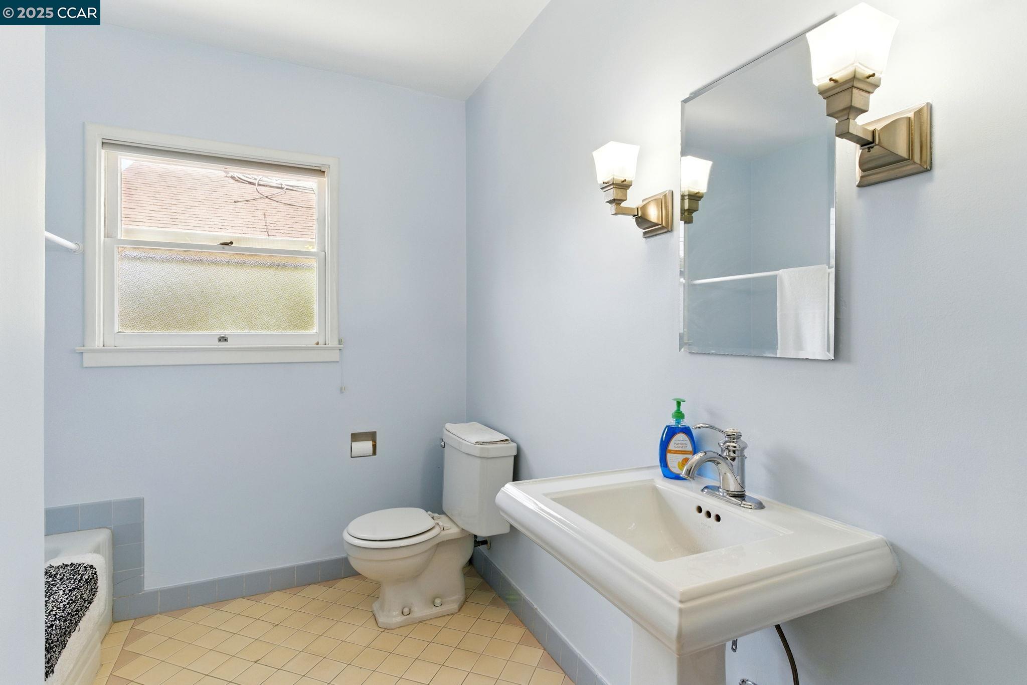 500 Wano Street Martinez, CA 94553 - Photo 25 of 30 a bathroom with a sink mirror and toilet