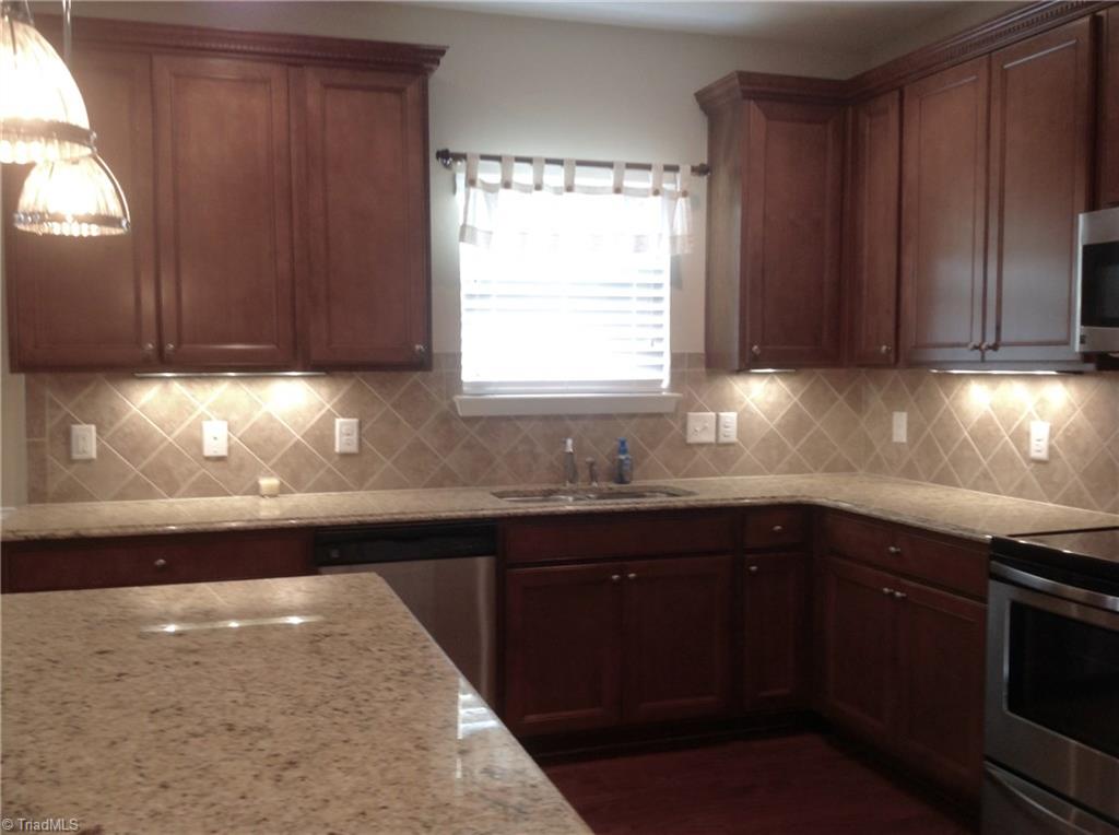 3406 Lamplight Way High Point, NC 27265 - Photo 11 of 29 Beautiful counter-tops and back splash upgrades for the neighborhood. There are under and above lights also. All the stainless steel appliances stay.