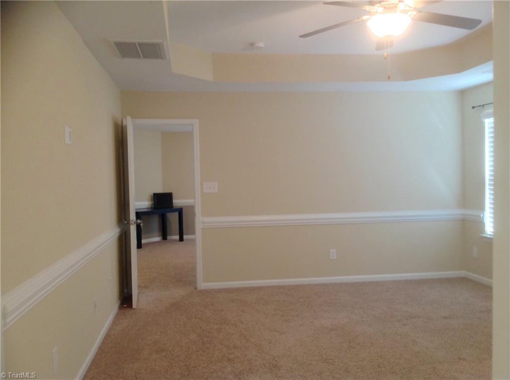 3406 Lamplight Way High Point, NC 27265 - Photo 15 of 29 Master bedroom with tray ceiling and sitting/loft just outside door.
