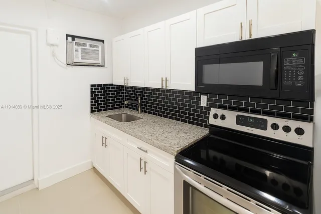 a close view of a stove a microwave and cabinets