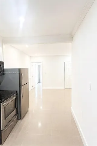 a kitchen with a refrigerator and a stove