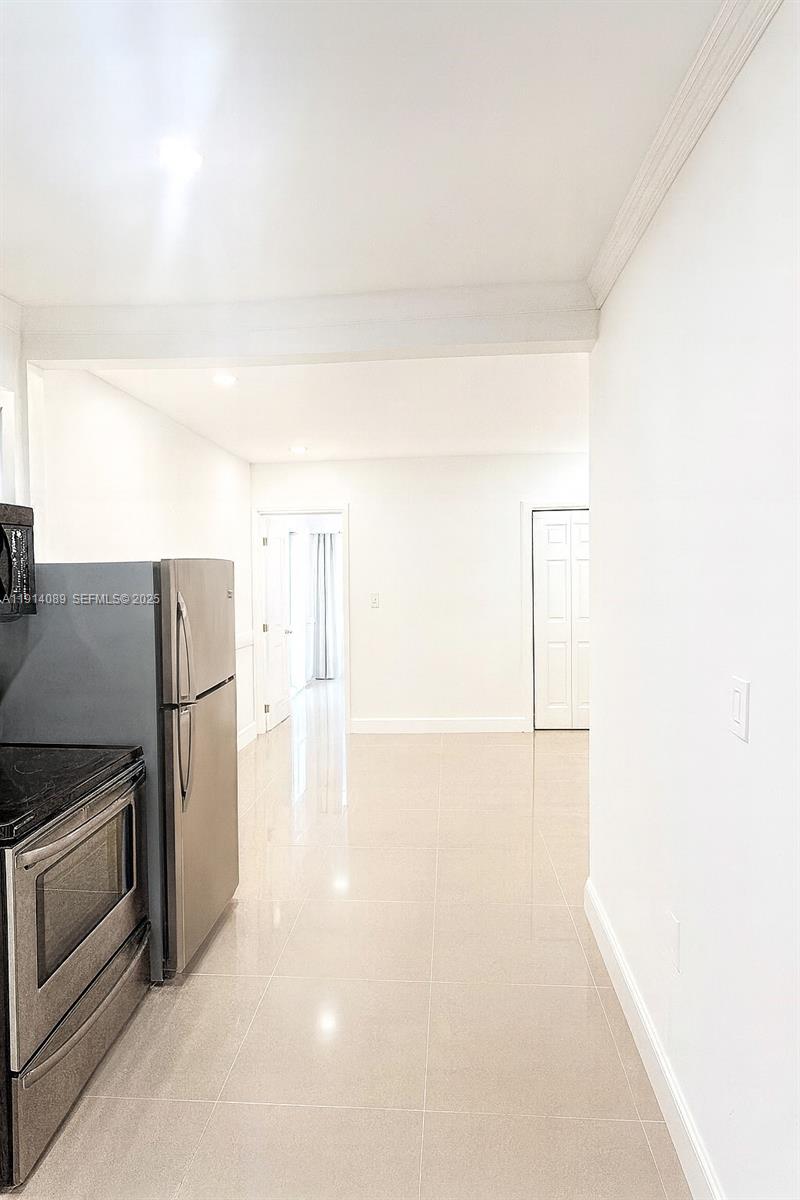 5807 Southwest 25th Street, Unit 9 West Park, FL 33023 - Photo 7 of 7 a kitchen with a refrigerator and a stove