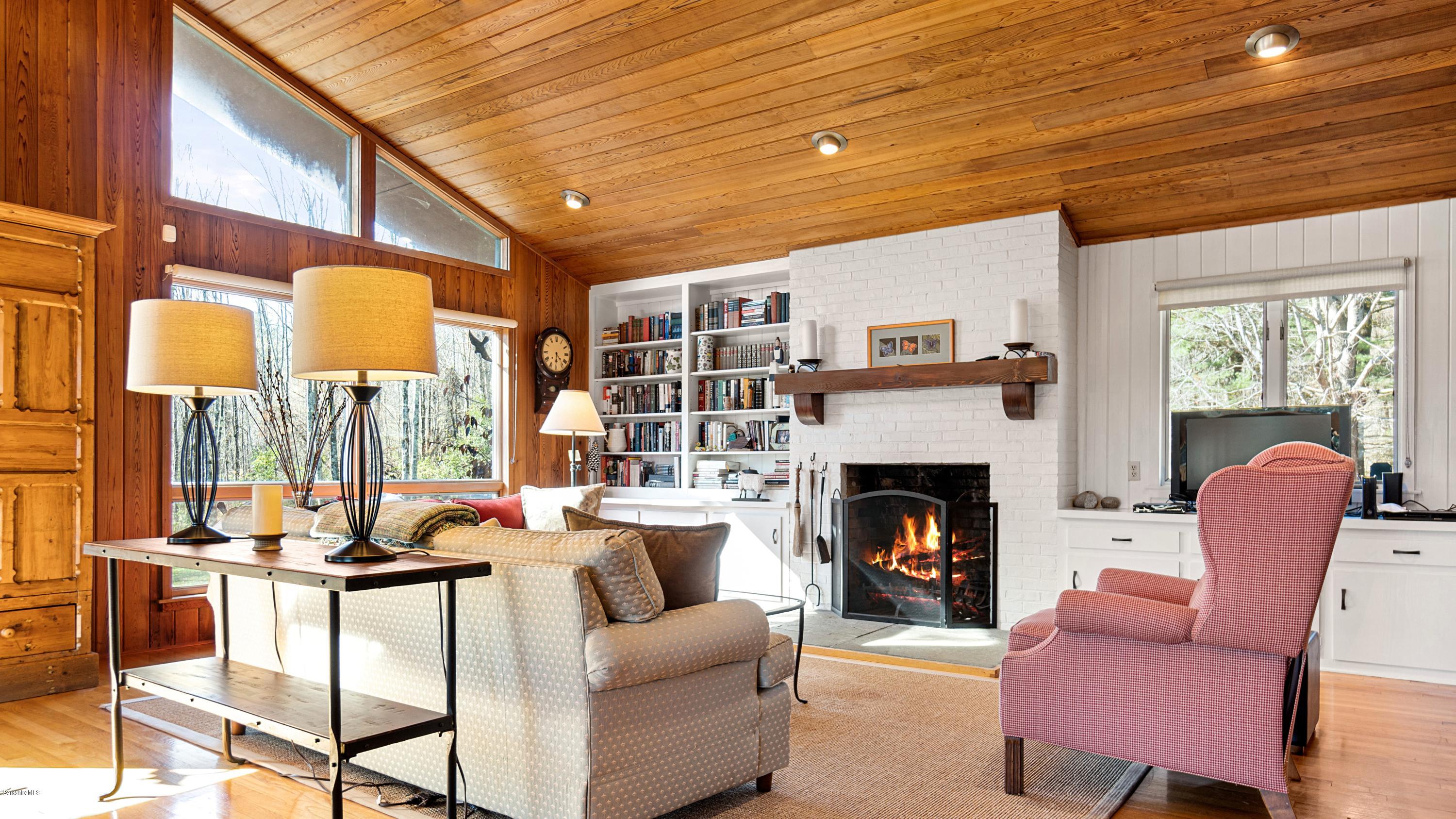 23 Interlaken Road Stockbridge, MA 01266 - Photo 3 of 26 a living room with furniture fireplace and a large window