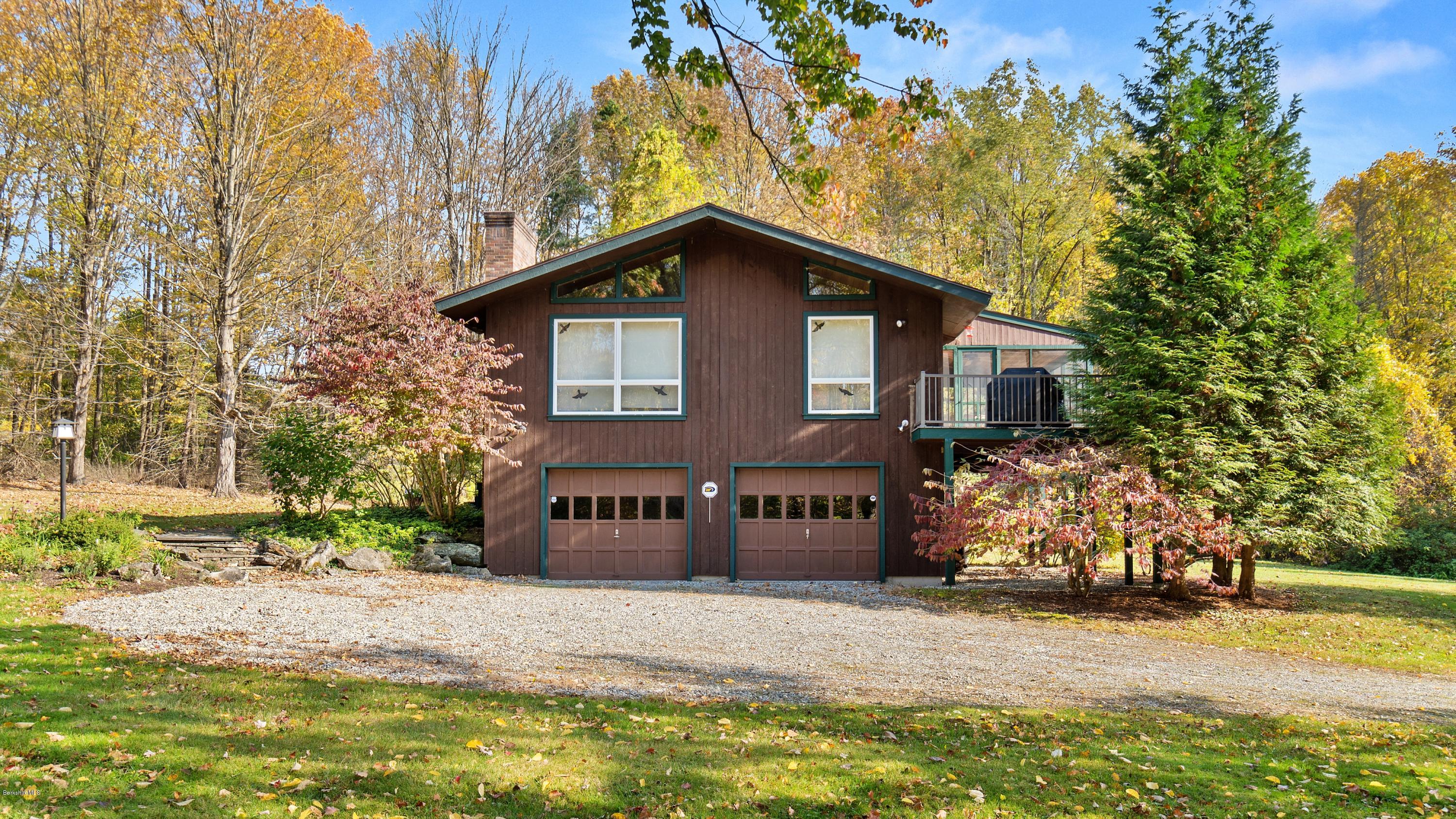 23 Interlaken Road Stockbridge, MA 01266 - Photo 22 of 26 a front view of house with yard and trees in the background