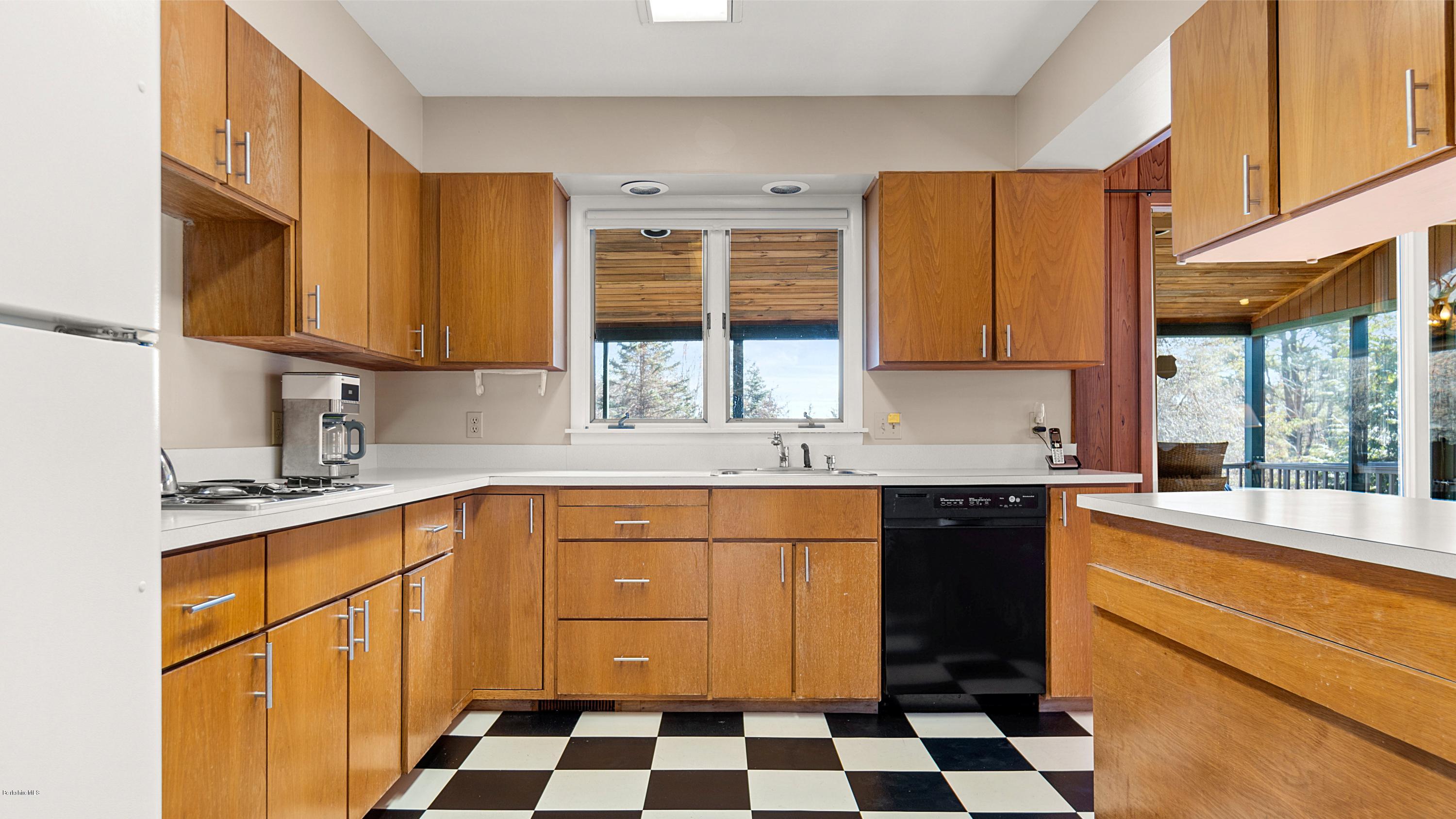 23 Interlaken Road Stockbridge, MA 01266 - Photo 8 of 26 a kitchen with a sink a stove cabinets and a window