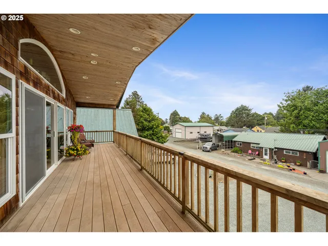 a balcony with wooden floor and city view