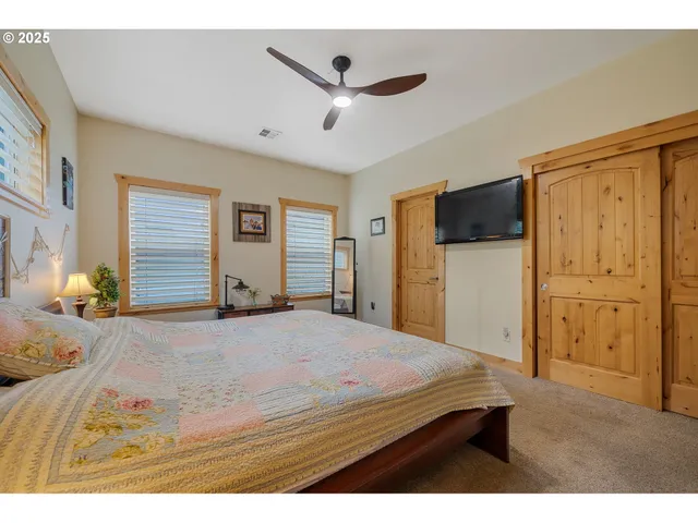 a bedroom with a bed and a flat screen tv