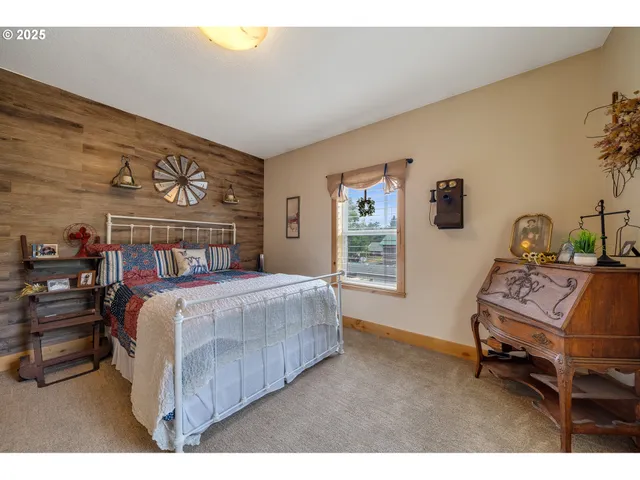 a bedroom with a bed a table and chair