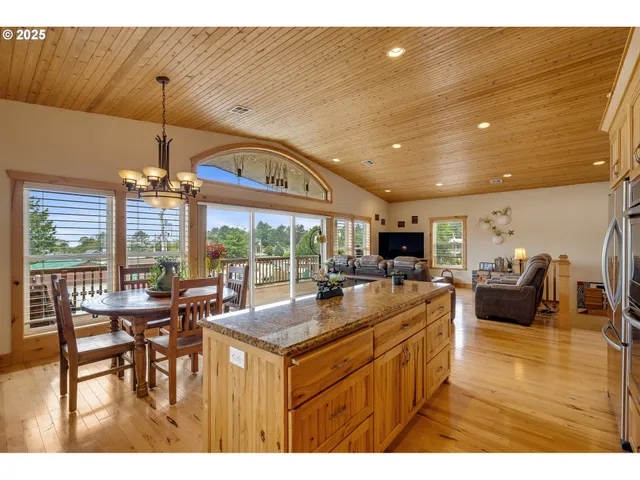 a kitchen with sink dining table and chairs
