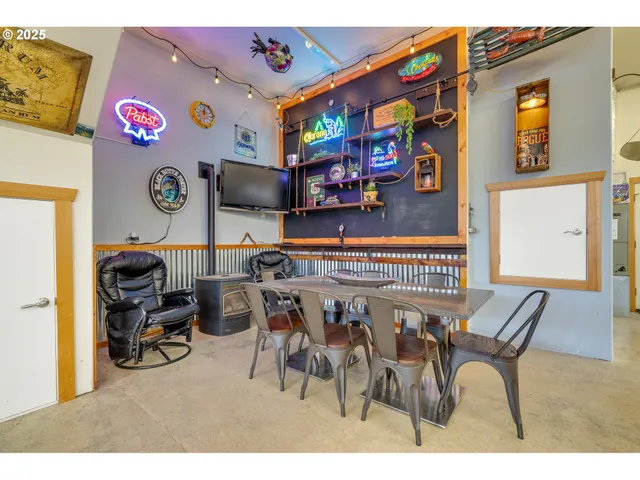 a dining area with furniture and a flat screen tv