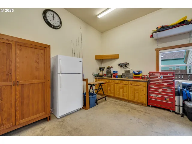 a kitchen with refrigerator and cabinets