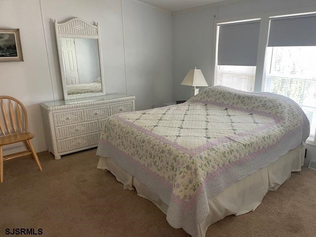 94 Center Ocean View, NJ 08230 - Photo 9 of 12 a bedroom with a bed and a window