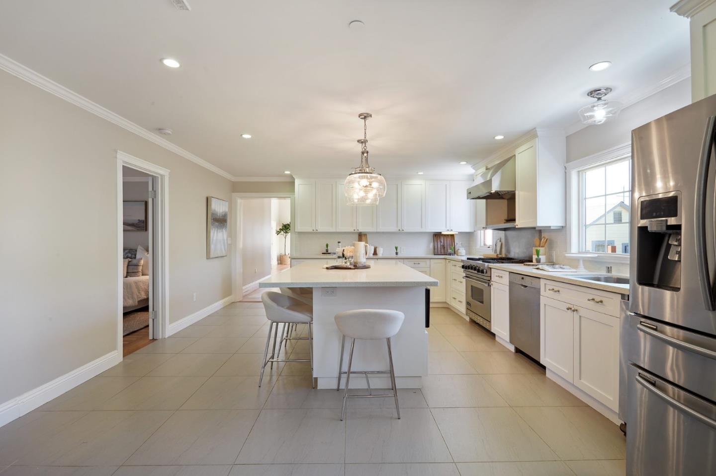 29 Bloomfield Road Burlingame, CA 94010 - Photo 13 of 54 a open kitchen with stainless steel appliances granite countertop a sink dishwasher a refrigerator and a dining table with wooden floor