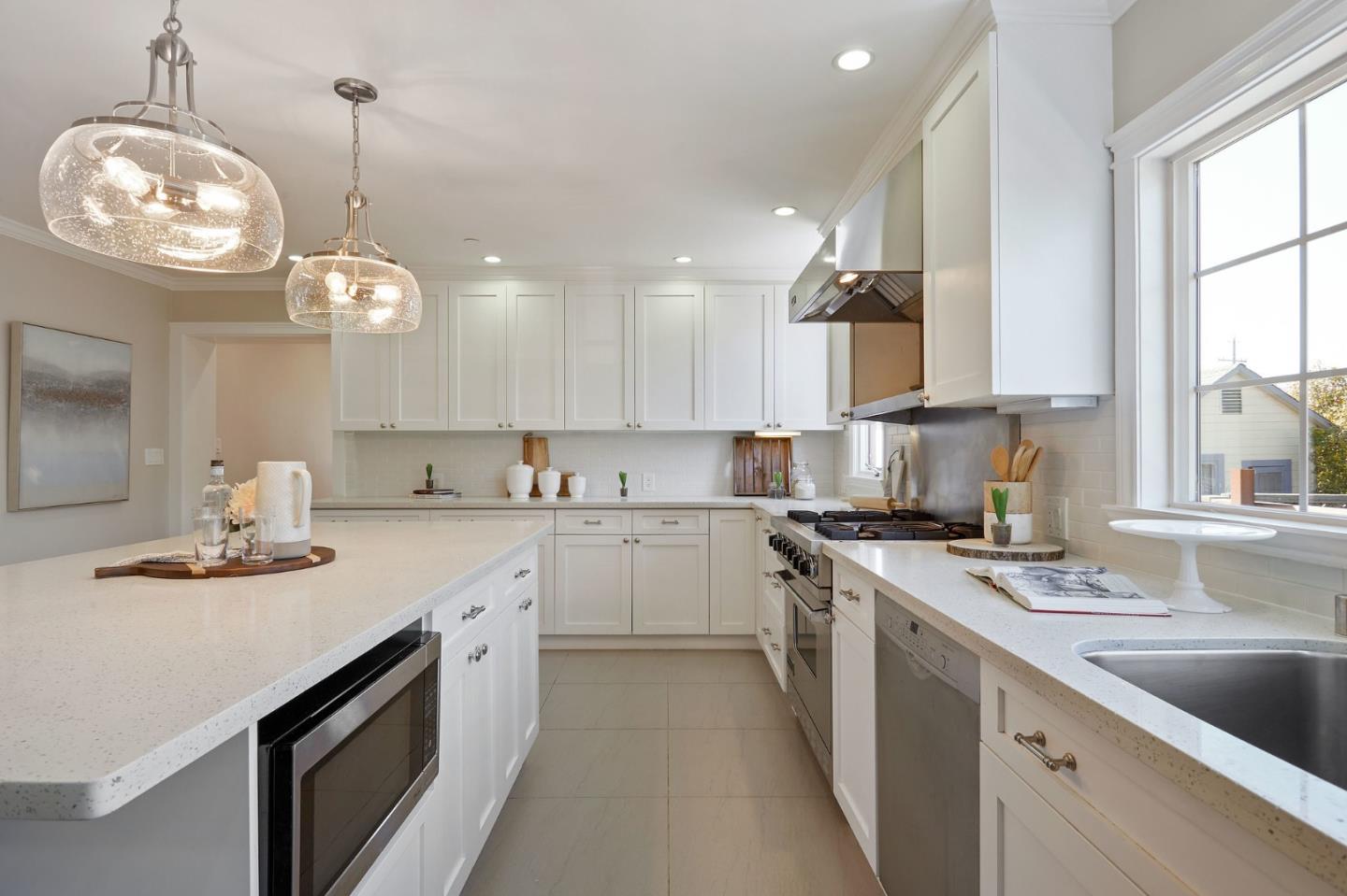 29 Bloomfield Road Burlingame, CA 94010 - Photo 16 of 54 a kitchen with a sink dishwasher a stove a microwave oven and a dining table with wooden floor