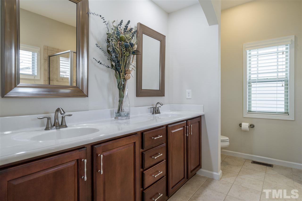 5630 Wade Park Boulevard Raleigh, NC 27607 - Photo 19 of 30 Owner's bathroom suite features double sinks, garden tub, ceramic tile, separate glass enclosed shower! Did we mention a tankless water heater!