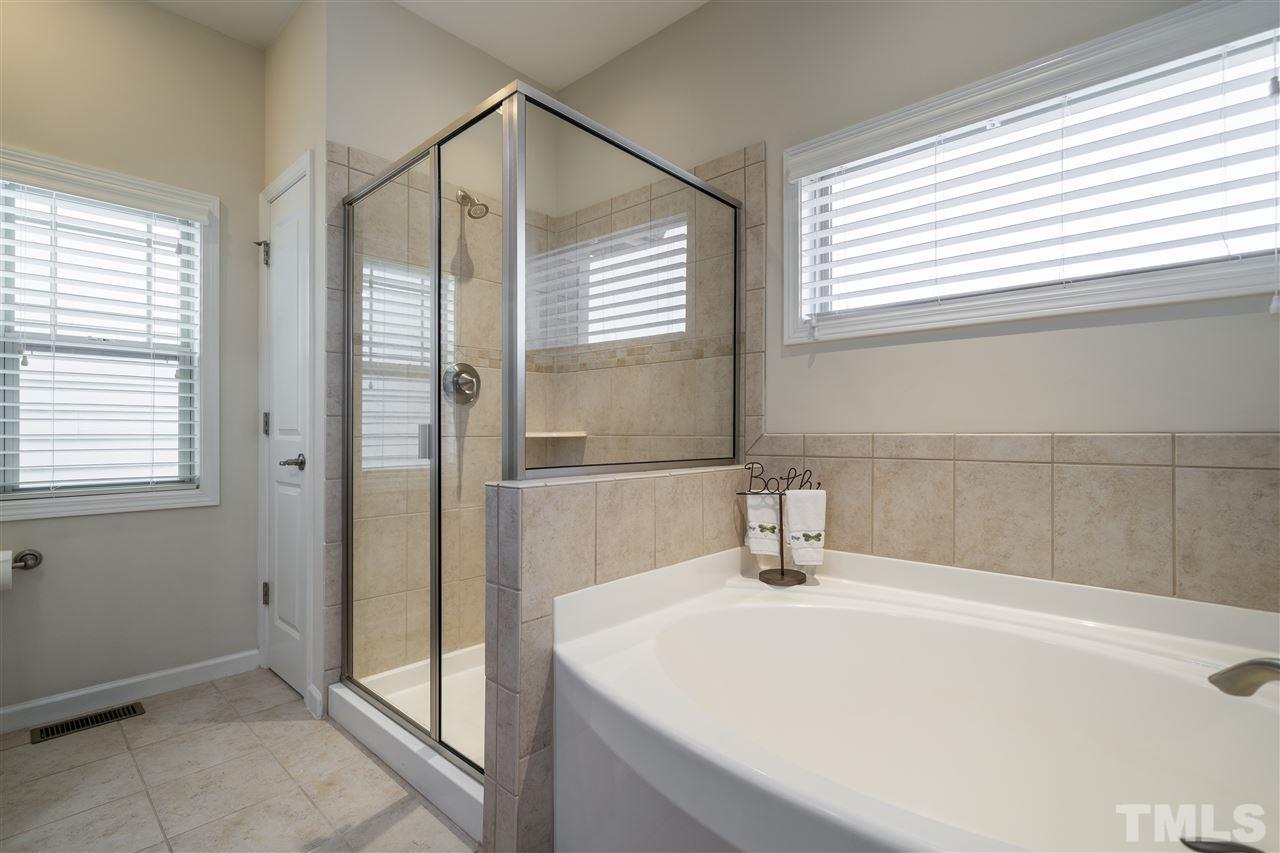 5630 Wade Park Boulevard Raleigh, NC 27607 - Photo 20 of 30 Owner's bathroom suite features double sinks, garden tub, ceramic tile, separate glass enclosed shower! Did we mention a tankless water heater!