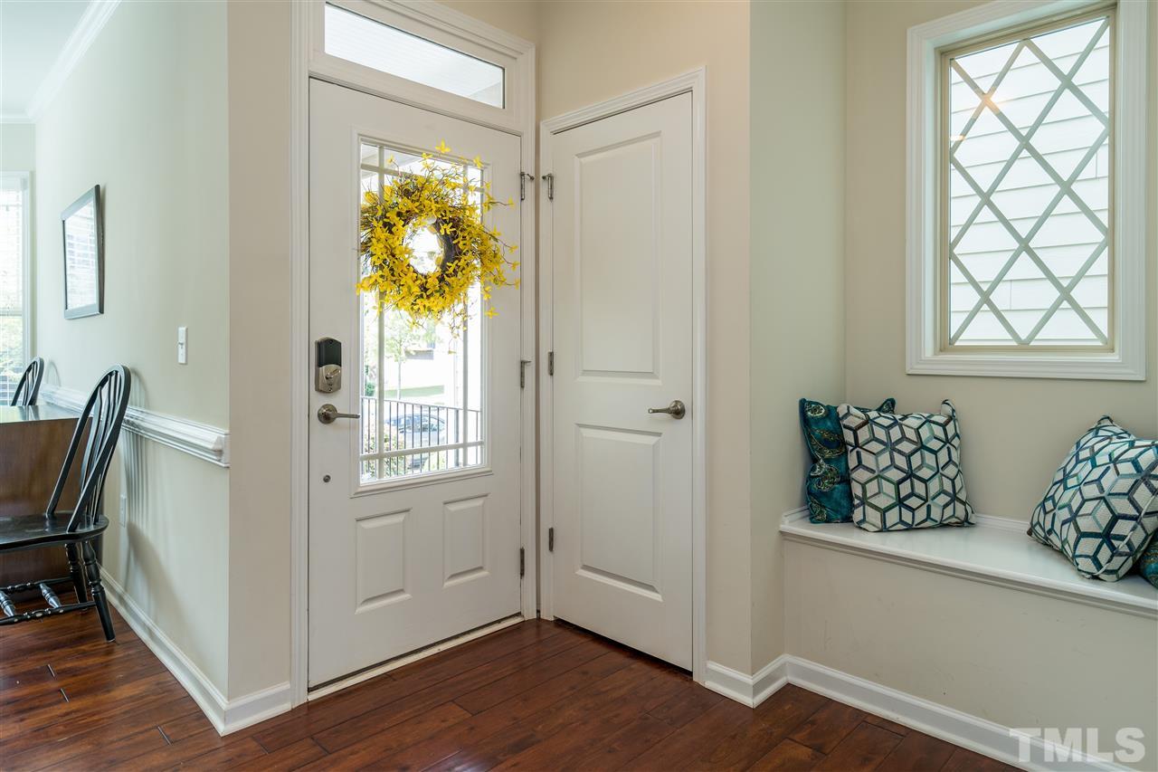 5630 Wade Park Boulevard Raleigh, NC 27607 - Photo 3 of 30 Just inside the front porch, this home has a coat closet, hardwood floors and bench for getting ready to head out the door!