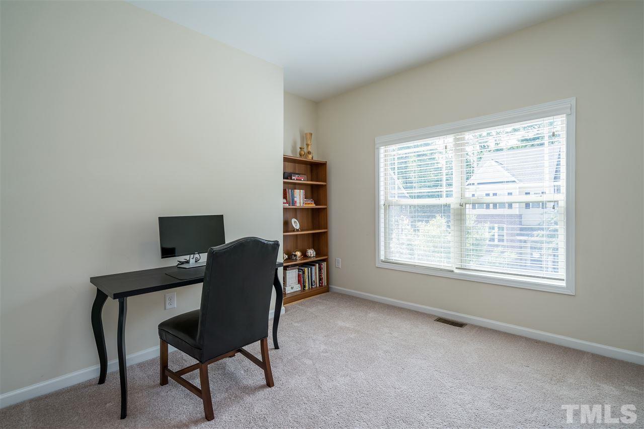 5630 Wade Park Boulevard Raleigh, NC 27607 - Photo 23 of 30 Large upstairs bedroom with blinds, closet with wooden shelving and cute alcove for your furniture!