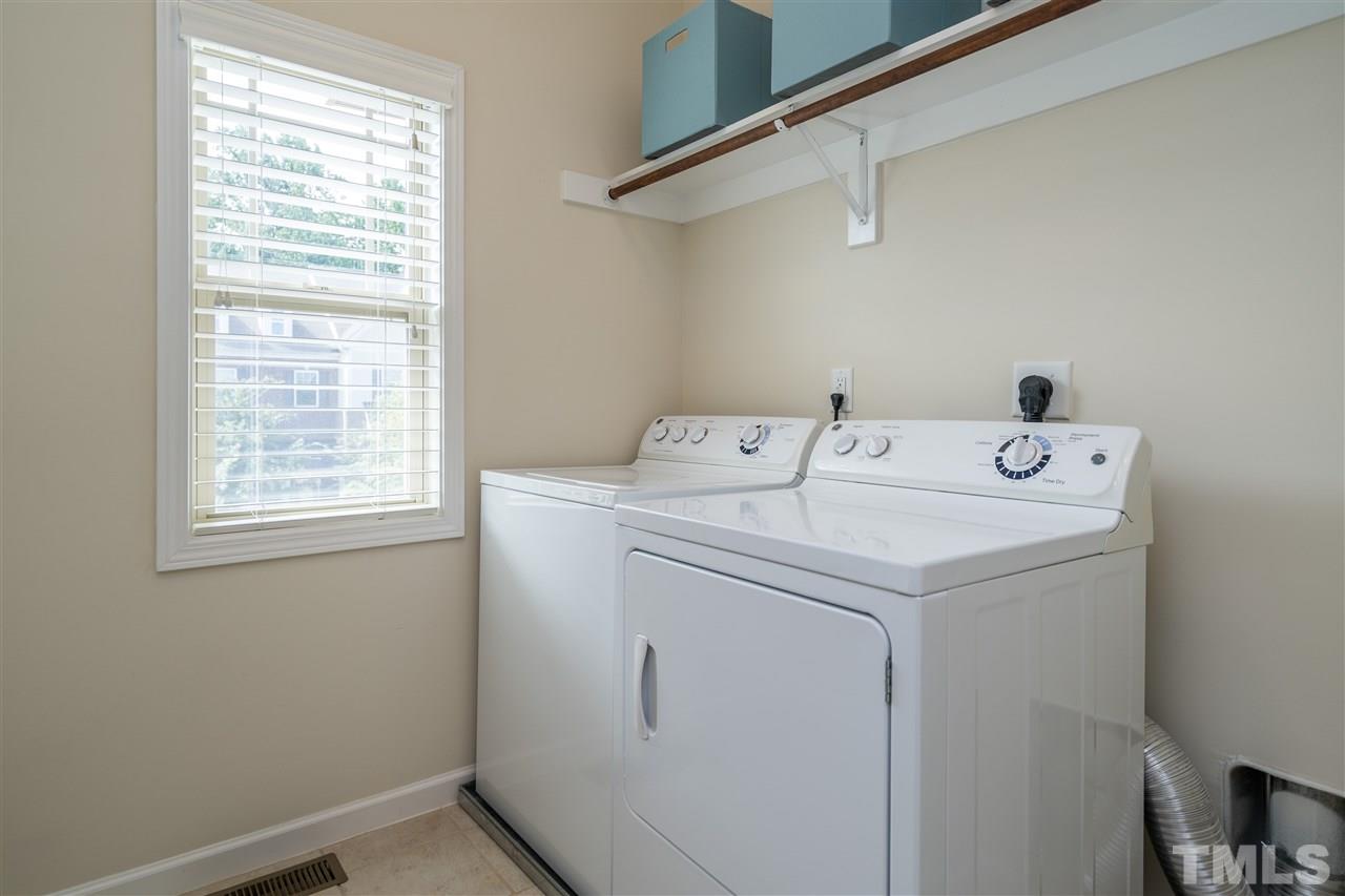 5630 Wade Park Boulevard Raleigh, NC 27607 - Photo 24 of 30 Washer and dryer included! Ceramic tile on the floors and wooden shelving above! Beautiful window with street view!