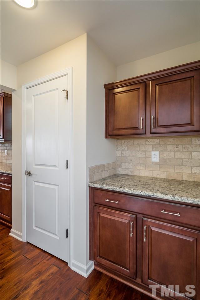 5630 Wade Park Boulevard Raleigh, NC 27607 - Photo 6 of 30 Butler's pantry connects the spacious dining room to the kitchen. Subway tile and granite make it a focal point and functional!