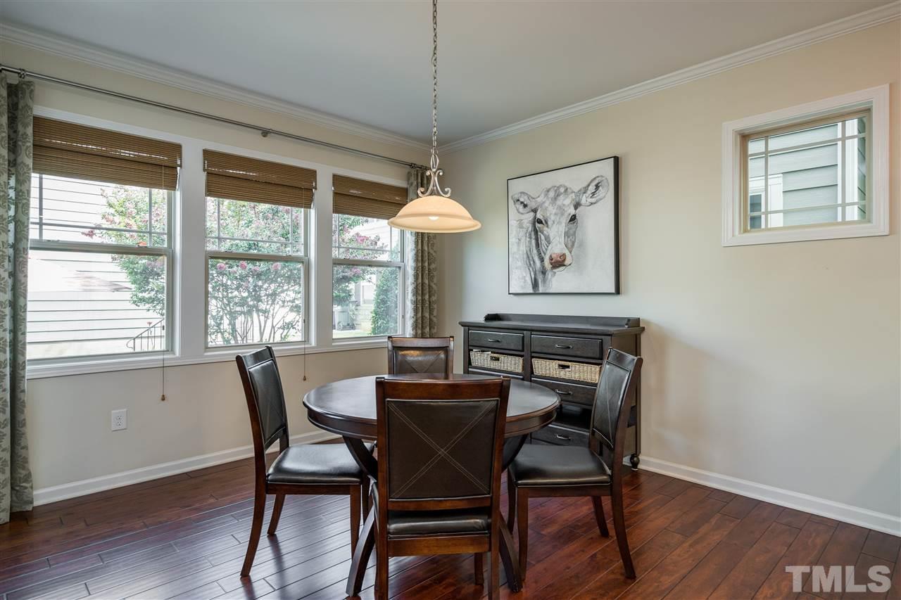 5630 Wade Park Boulevard Raleigh, NC 27607 - Photo 9 of 30 Convenient breakfast nook with plenty of space for everyday meals opens to the kitchen bar and the living room for easy entertaining!
