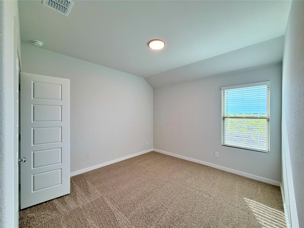 2203 Heatwave Lane Princeton, TX 75407 - Photo 11 of 32 an empty room with windows and closet