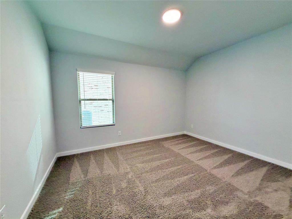 2203 Heatwave Lane Princeton, TX 75407 - Photo 12 of 32 an empty room with a window